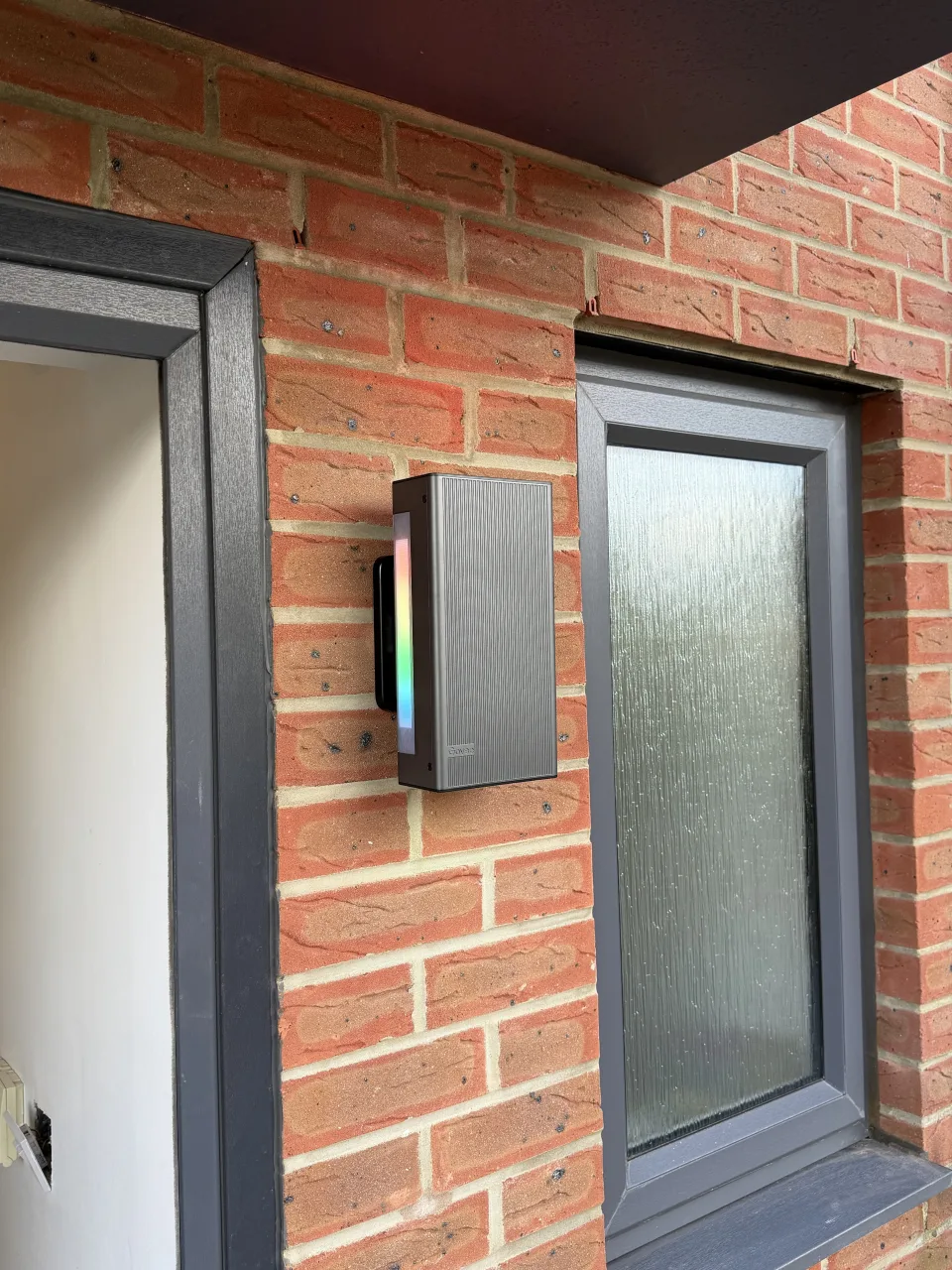 New wall-mounted outdoor porch light switched on after replacement